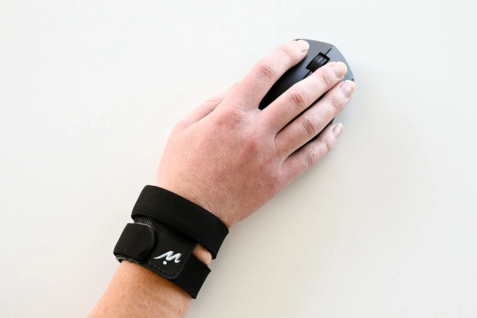 Person with wrist pain at work using Wrist Warrior for everyday comfort and wrist support